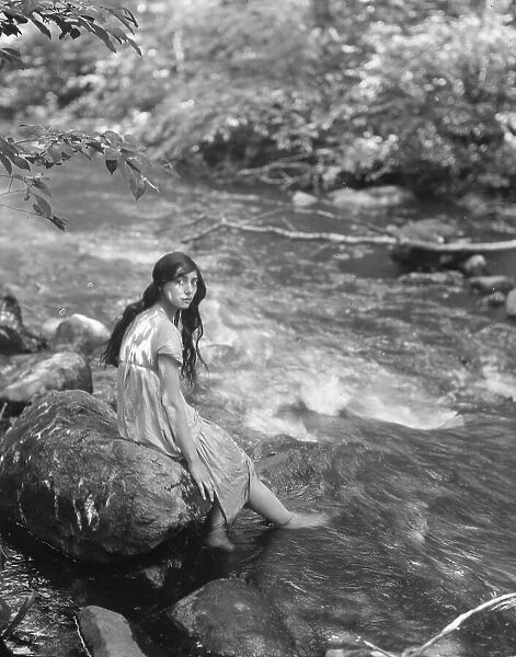 Cowan, Rosamonde, Miss (Rose Rolanda ; Mrs. Miguel C.), seated by a stream, 1919 May 24. Creator: Arnold Genthe