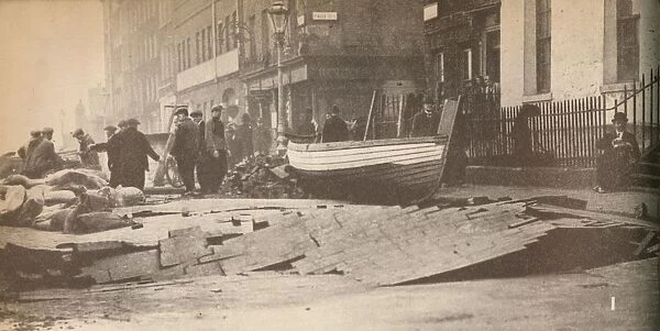 Damage caused on the Victoria Embankment when the Thames burst its banks and caused a number of fat