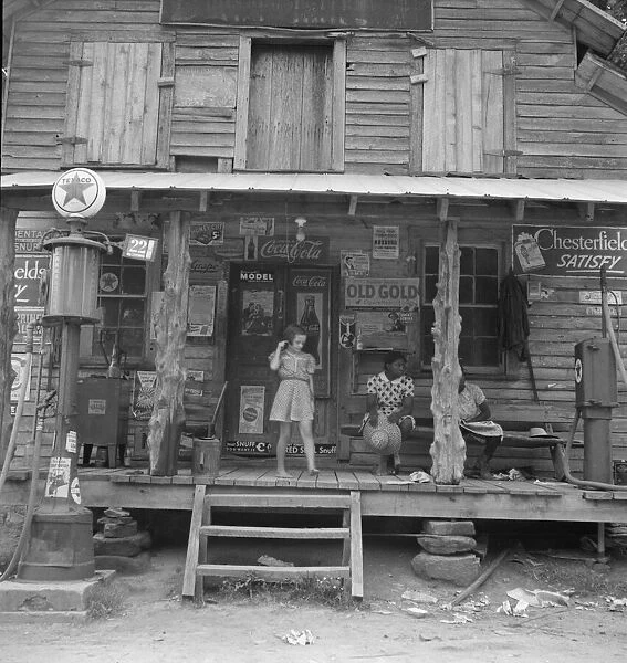 Daughter of white tobacco sharecropper at country store, Person County, North Carolina, 1939. Creator: Dorothea Lange