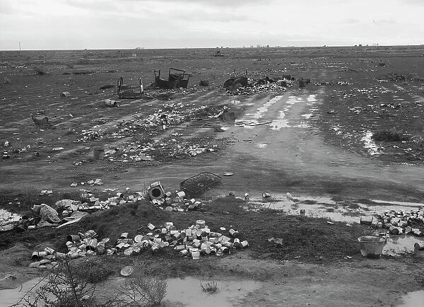 Debris left out on the flats where squatters camp stood during work season, Kern County, 1939. Creator: Dorothea Lange