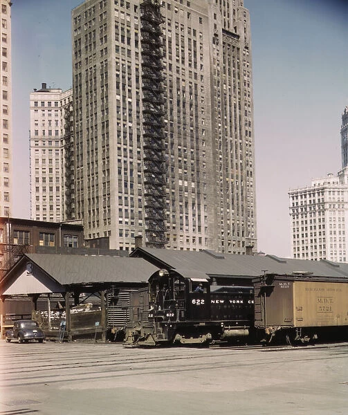 Diesel switch engine moving freight cars at the South water...Illinois Central R.R. Chicago, 1943. Creator: Jack Delano