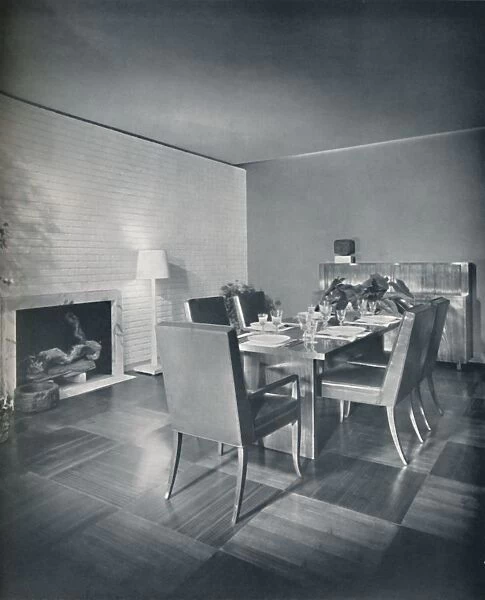 Dining-room furniture with leather-upholstered chairs designed by T. H. Robsjohn-Gibbings