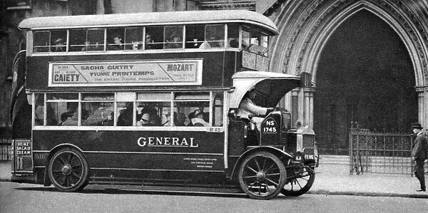 A double-decker bus standing outside the Law Courts, London, 1926-1927
