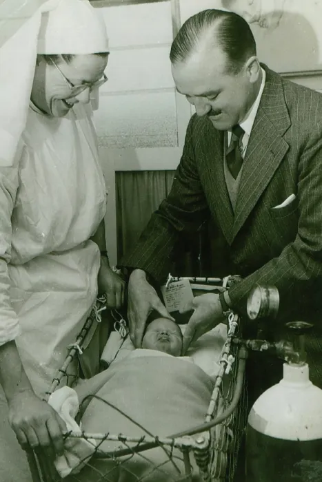 Framed Print : Dr Geoffrey Mutton and Matron Joan Gardner attend to a baby at St Monan's Hospital, c1950 Framed Print : Dr Geoffrey Mutton and Matron Joan Gardner attend to a baby at St Monan's Hospital, c1950