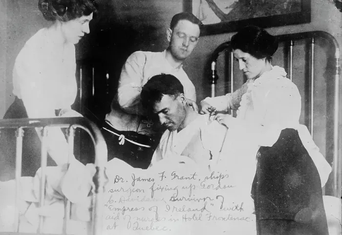 Framed Print : Dr. James F. Grant, ship's surgeon, fixing up Gordon G. Davidson, survivor of EMPRESS OF... 1914. Creator: Bain News Service Framed Print : Dr. James F. Grant, ship's surgeon, fixing up Gordon G. Davidson, survivor of EMPRESS OF... 1914. Creator: Bain News Service