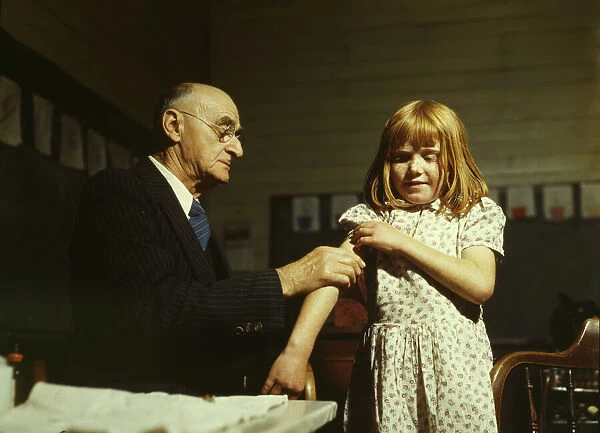 Dr. Schreiber of San Augustine giving a typhoid innoculation... San Augustine County, Texas, 1943. Creator: John Vachon