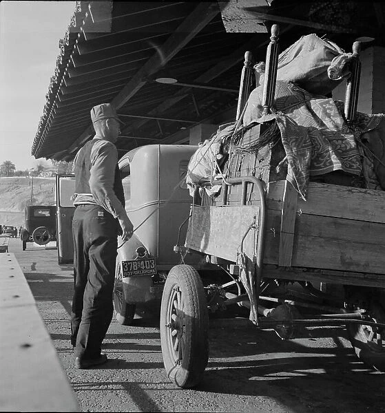 Drought refugees are stopped at the inspection station in Yuma, Arizona, 1937. Creator: Dorothea Lange