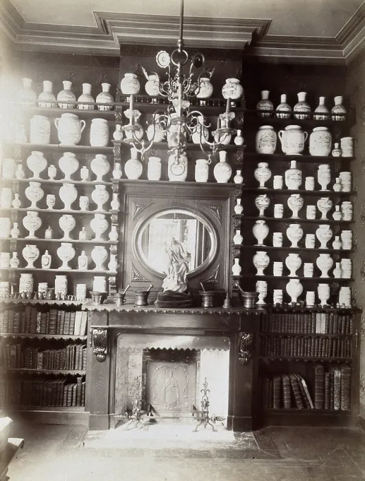 Framed Print : Drug jars and books on shelves surrounding a mantlepiece with a statue and a mirror, c1900.. Creator: Unknown Framed Print : Drug jars and books on shelves surrounding a mantlepiece with a statue and a mirror, c1900.. Creator: Unknown