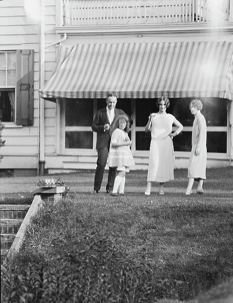 Dunning family, standing outside house, 1925 July 9. Creator: Arnold Genthe