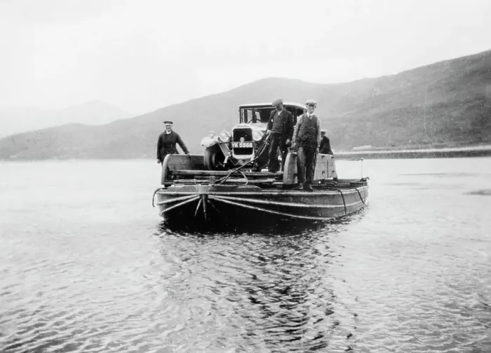 Framed Print : An early ferry transporting a car across a lake Framed Print : An early ferry transporting a car across a lake