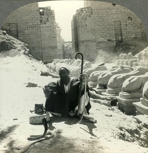 An Egyptian Snake Charmer Piles His Trade Beside the Avenue of Sphinxes, Temple of Karnak