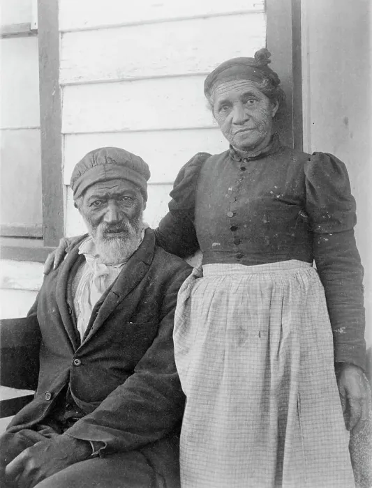 Framed Print : Elderly African American couple posed outside of building, near Hampton Institute... 1899 or 1900. Creator: Frances Benjamin Johnston Framed Print : Elderly African American couple posed outside of building, near Hampton Institute... 1899 or 1900. Creator: Frances Benjamin Johnston