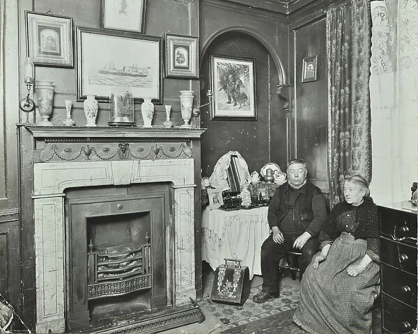 Elderly couple in Victorian interior, Albury Street, Deptford, London, 1911