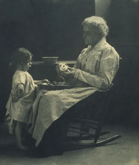 Framed Print : Elderly woman in a rocking chair peeling apple with young girl standing in front of her, c1900. Creator: Elizabeth B. Brownell Framed Print : Elderly woman in a rocking chair peeling apple with young girl standing in front of her, c1900. Creator: Elizabeth B. Brownell