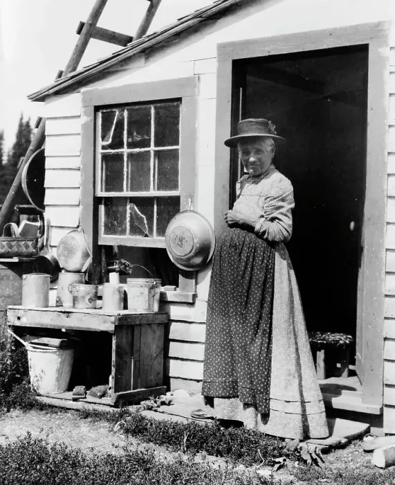 Framed Print : Elderly woman, standing at doorway, on Mackinac Island, Michigan, 1903. Creator: Frances Benjamin Johnston Framed Print : Elderly woman, standing at doorway, on Mackinac Island, Michigan, 1903. Creator: Frances Benjamin Johnston