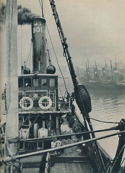 Entering Grimsby Docks at the end of a North Sea voyage is the fishing vessel Saurian, 1937