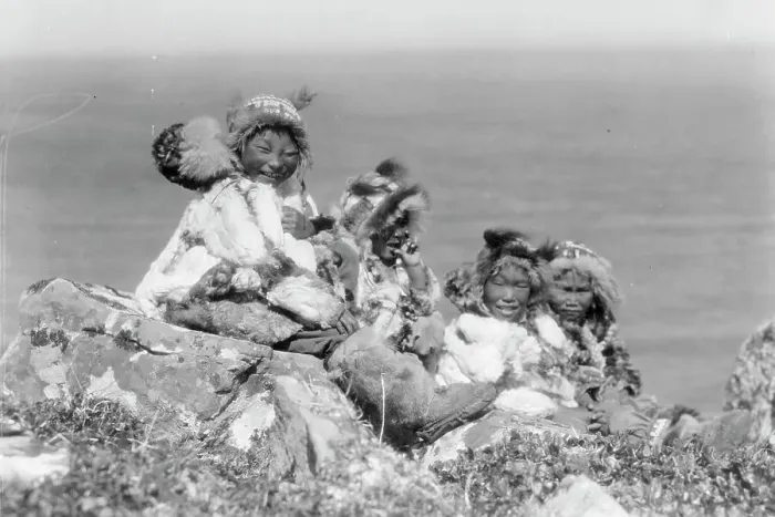 Framed Print : Four Eskimo children, at edge of cliff, in holiday costume, Nunivak, Alaska, c1929. Creator: Edward Sheriff Curtis Framed Print : Four Eskimo children, at edge of cliff, in holiday costume, Nunivak, Alaska, c1929. Creator: Edward Sheriff Curtis