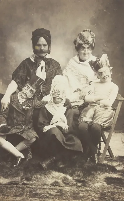 Framed Print : A family, all members wearing grotesque masks, the father in drag, c1910. Creator: Unknown Framed Print : A family, all members wearing grotesque masks, the father in drag, c1910. Creator: Unknown