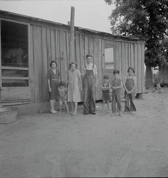 Part of a family of ten children who live and farm in the area, Arkansas, 1937. Creator: Dorothea Lange