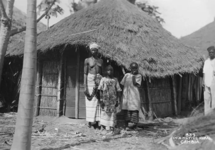 Framed Print : A family in front of their home, Gambia, 20th century Framed Print : A family in front of their home, Gambia, 20th century