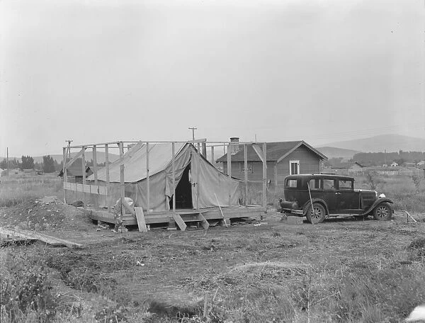 Family living in tent while building the house around them, near Klamath Falls, Oregon, 1939. Creator: Dorothea Lange