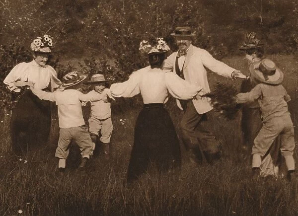 Family playing games in a field, 1937