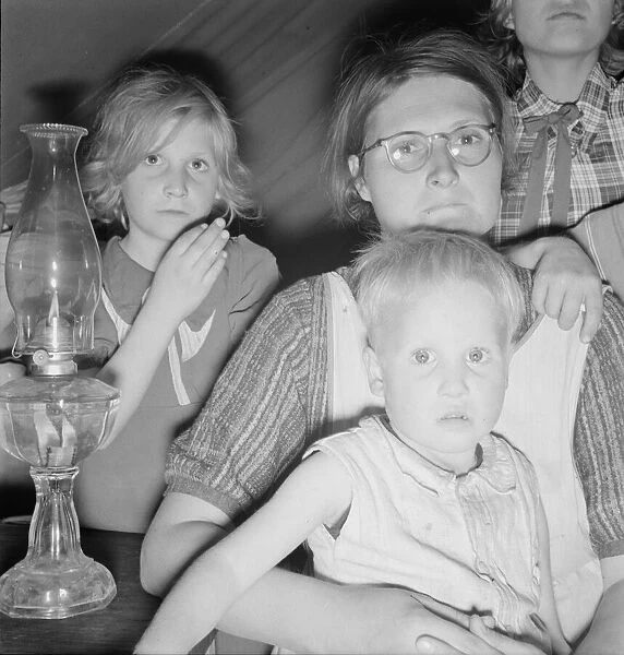 Family of six in tent after supper, FSA mobile unit, Merrill, Klamath County, Oregon, 1939. Creator: Dorothea Lange