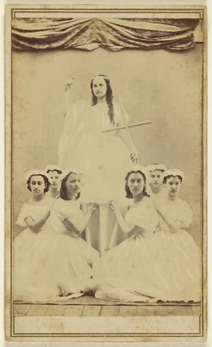 Framed Print : Female group portrait, six in white gowns kneeling, one standing holding a cross, about 1865. Creator: Unknown Framed Print : Female group portrait, six in white gowns kneeling, one standing holding a cross, about 1865. Creator: Unknown