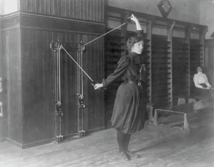 Framed Print : Female student exercising with a wall-mounted device using ropes and... Washington, DC, (1899?). Creator: Frances Benjamin Johnston Framed Print : Female student exercising with a wall-mounted device using ropes and... Washington, DC, (1899?). Creator: Frances Benjamin Johnston