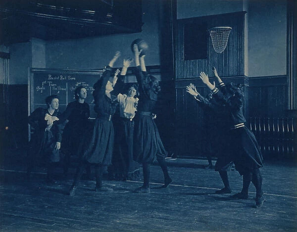 Female students playing basketball in a gymnasium, Western High School, Washington, D.C. (1899?). Creator: Frances Benjamin Johnston