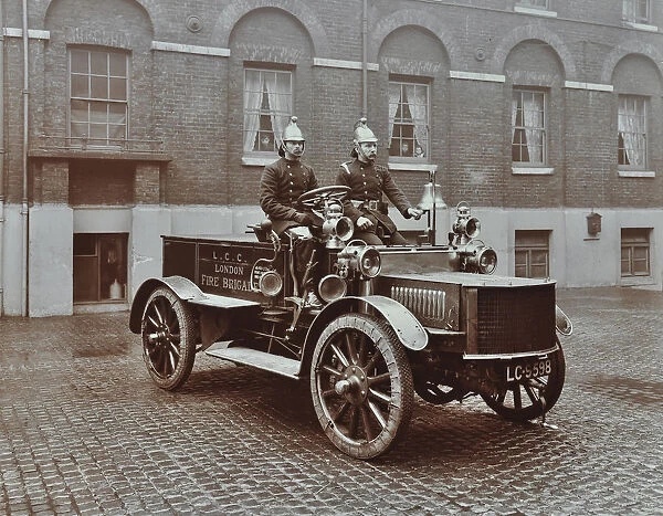 Firemen in brass helmets aboard a motor hose tender, London Fire Brigade Headquarters, London, 1909
