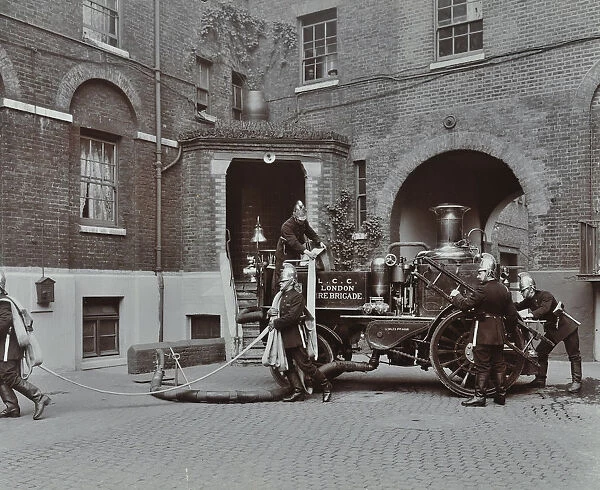 Firemen demonstrating motor steamer hoses, London Fire Brigade Headquarters, London, 1910