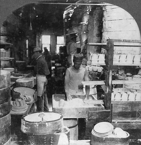 Firing tableware in the Noted Pottery Centre, Trenton, New Jersey, USA, early 20th century. Artist: Keystone View Company