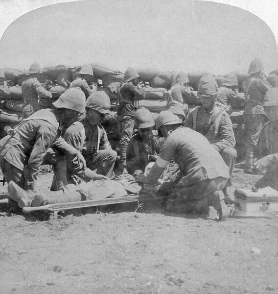 First aid to a wounded fusilier, Honey Nest Kloof Battle, Boer War, South Africa, February 1900. Artist: Underwood & Underwood