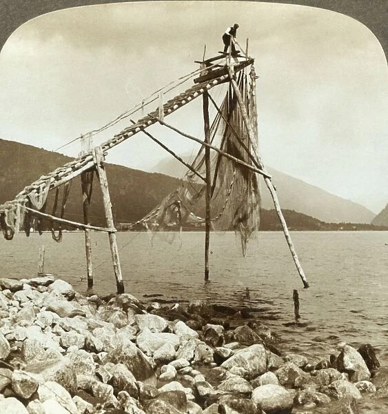 Fisherman arranging salmon nets at Balestrand on Sognefjord - Balholm in distance
