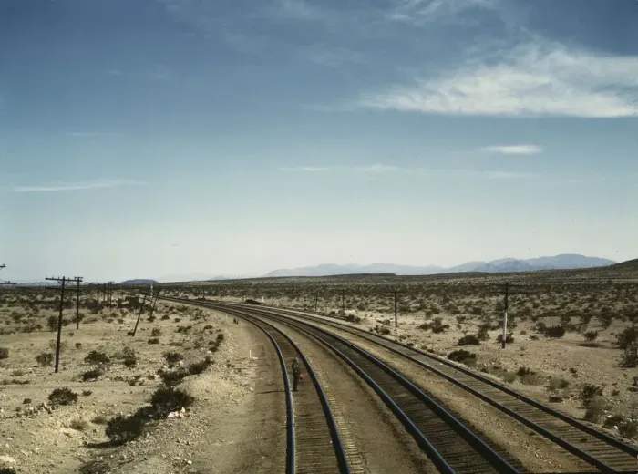 Framed Print : Flagman standing at a distance behind a Santa Fe R.R. west bound freight... Bagdad, Calif. 1943. Creator: Jack Delano