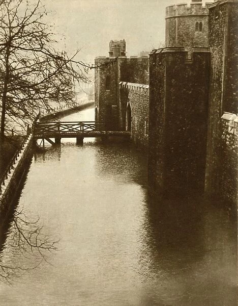 Flood waters in the moat at the Tower of London, 1928, (1935). Creator: Unknown