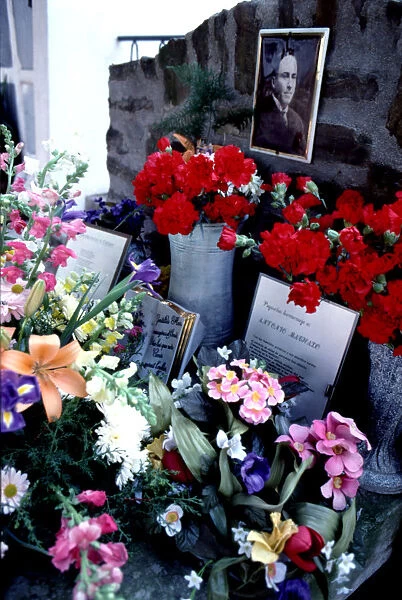Flower-filled tomb in the cemetery of Cotlliure with the picture of Antonio Machado (1875-1939)
