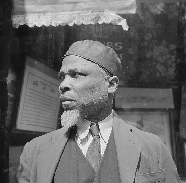 A follower of the late Marcus Garvey who started the 'Back to Africa'movement, New York, 1943. Creator: Gordon Parks
