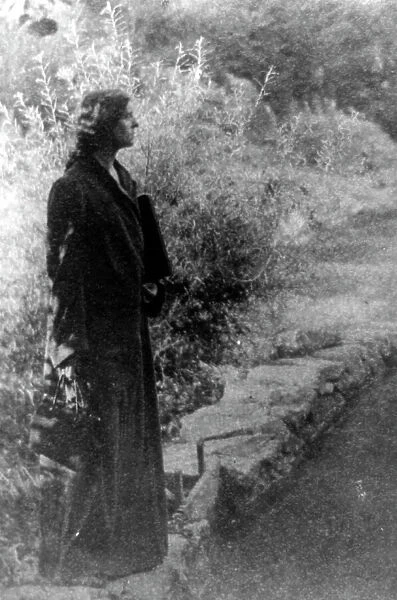 Frances Benjamin Johnston, full-length portrait, standing in garden, right profile, c1880 - 1950. Creator: Gertrude Kasebier