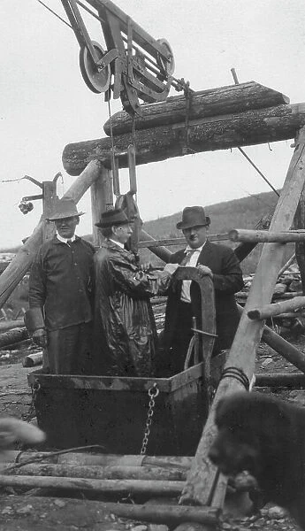 Frank G. Carpenter in middle of bucket at gold mine, between c1900 and 1916. Creator: Unknown