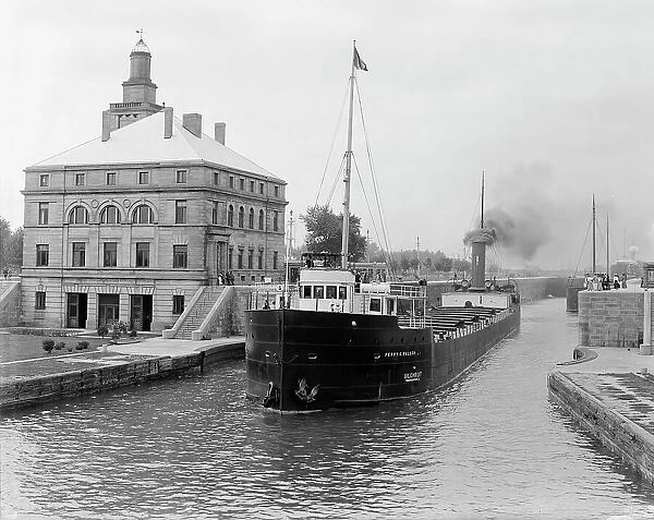 Freighter in Poe Lock, looking down, Sault Ste. Marie, Mich. between 1903 and 1910. Creator: Unknown