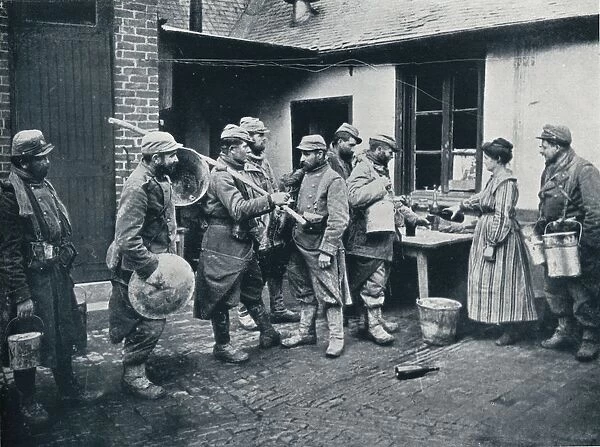 French soldiers returning from the trenches make a halt for refreshment, c1914