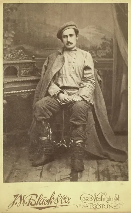 Framed Print : Full-length portrait of a man in convict clothing and leg irons, seated... between 1880 and 1886. Creator: Unknown Framed Print : Full-length portrait of a man in convict clothing and leg irons, seated... between 1880 and 1886. Creator: Unknown