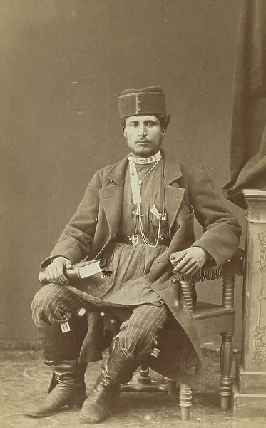 Full-length portrait of Persian man, seated, facing front, between 1870 and 1886. Creator: Unknown