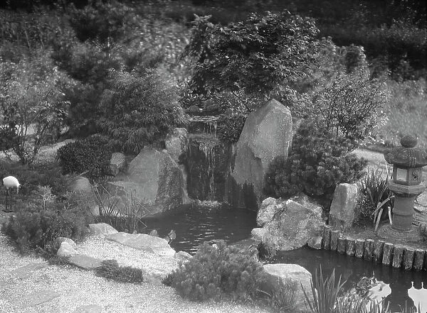 Garden with a Japanese waterfall and a stone lantern, possibly belonging to A.W. Bahr, c1917-1934. Creator: Arnold Genthe