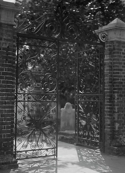 Gates on Broad Street to the graveyard at St. Michael's Episcopal Church, Charleston... c1920-1926. Creator: Arnold Genthe