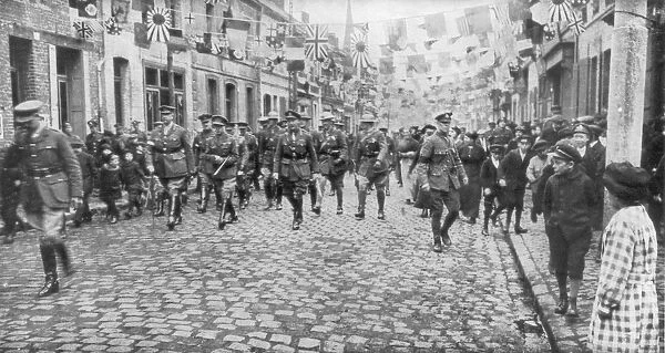 General Currie and Canadian troops walking through a liberated town, 27 October 1918