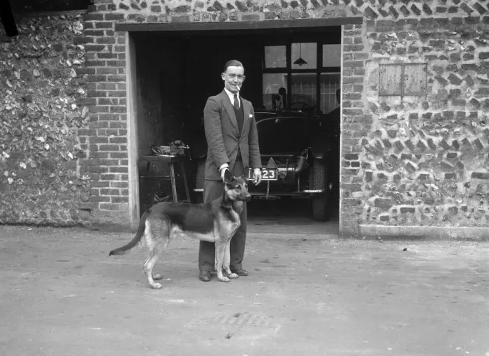 Framed Print : Geoffrey Baker and his alsatian. Artist: Bill Brunell Framed Print : Geoffrey Baker and his alsatian. Artist: Bill Brunell
