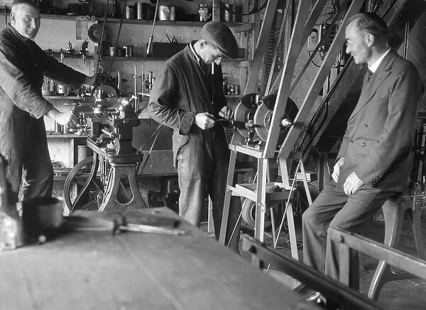 Geoffrey Baker with two other men in a workshop. Artist: Bill Brunell